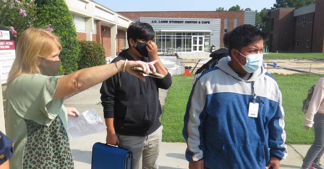
			
				                                Principal Joy Harrelson directing students to where they need to be on the first day of school.
                                 Matthew Sasser | Daily Journal

			
		