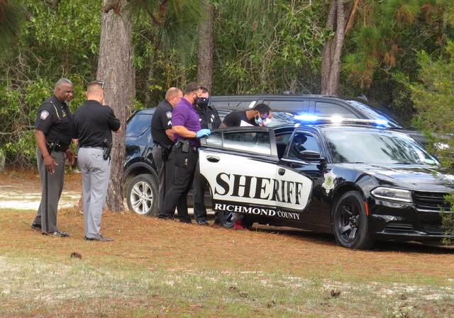 
			
				                                Deputies escort Antonio Xavier Edens into a cruiser following the chase.
 
			
		