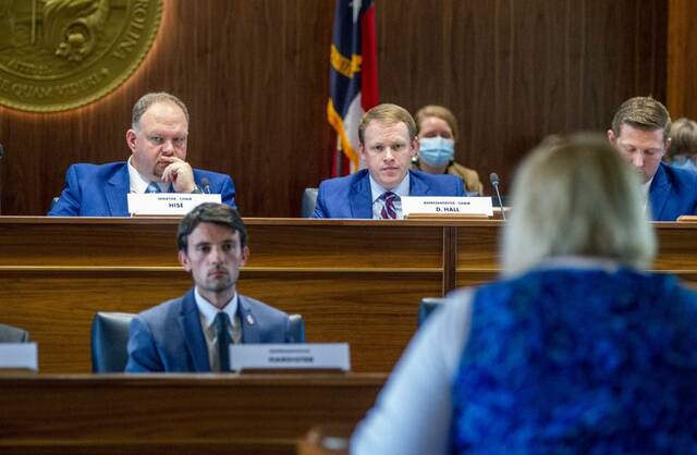 127984295_web1_APprimary
Travis Long | The News & Observer via AP, File
Top state redistricting legislators, Sen. Paul Hise, top left, and Rep. Destin Hall, top right, listen as several dozen members of the public address state lawmakers during a public comment hearing on Senate and House legislative redistricting maps Monday, Oct. 25, 2021, at the Legislative Building in Raleigh, N.C. On Wednesday, Dec. 8 the state Supreme Court ordered the candidate filing period for districts approved by the General Assembly and for other offices be delayed while redistricting litigation is considered.