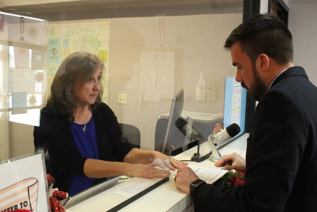 
			
				                                Board of Commissioners Vice Chairman Justin Dawkins files for his first full term in his seat after serving out the remainder of Ben Moss’s term. Elections Director Connie Kelly shows the candidate where to sign.
                                 Daily Journal file photo

			
		