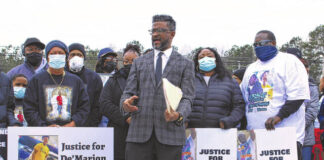
			
				                                Matthew Sasser | Daily Journal
                                From left, Tyrone Davis, John Barnett, Melinda Ellerbe Crank, and Anthony Johnson at the press conference on Tuesday across the street from the scene of the shooting, the 74 Car Wash. Davis is De’Marion’s father, Crank and Johnson are Malik’s mother and father.
 
			
		
