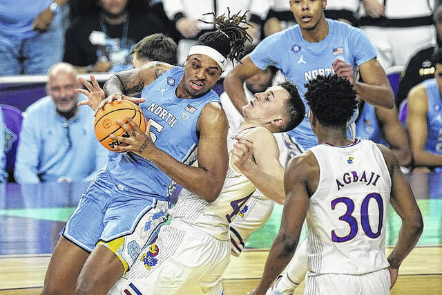 128414103_web1_APbacot4
AP Photo | Gerald Herbert
Kansas forward Mitch Lightfoot, right, draws the foul against North Carolina forward Armando Bacot (5) during the second half of a college basketball game in the finals of the Mens Final Four NCAA tournament, Monday, April 4, 2022, in New Orleans.