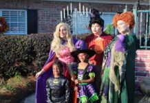 
			
				                                Brayden Everette and Brooklyn Wall get a picture next to the burning cauldron of the Sanderson witches. The immaculate witches were portrayed by Mia Franco, Kinnley Micklem and Miranda Watson as Sarah, Mary and Winifred respectively.
                                 Matthew Sasser | Daily Journal

			
		