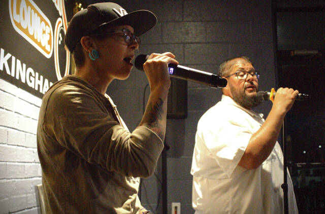 130636316_web1_converted_664f8d625c6a2
Courtney Boston Vargas and Brian Leviner sing a duet during Wednesdays Bow Tie Entertainment Karaoke Night inside Strikers Loung.